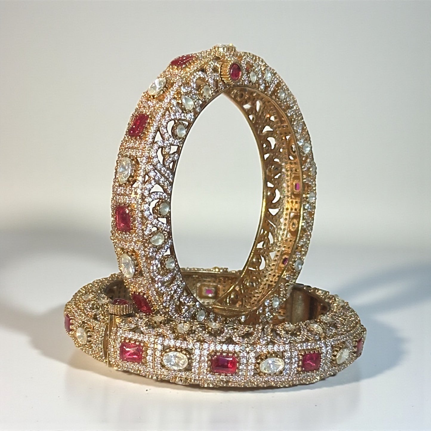 Handcrafted gold-tone kundan bangle with ruby and polki stones for Indian bridal wear