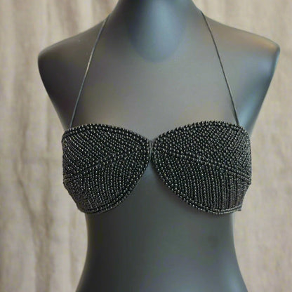Black beaded bra on a mannequin against a neutral background
