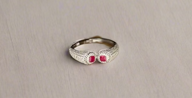 rhodium polish bracelet with red gemstones on a wooden surface